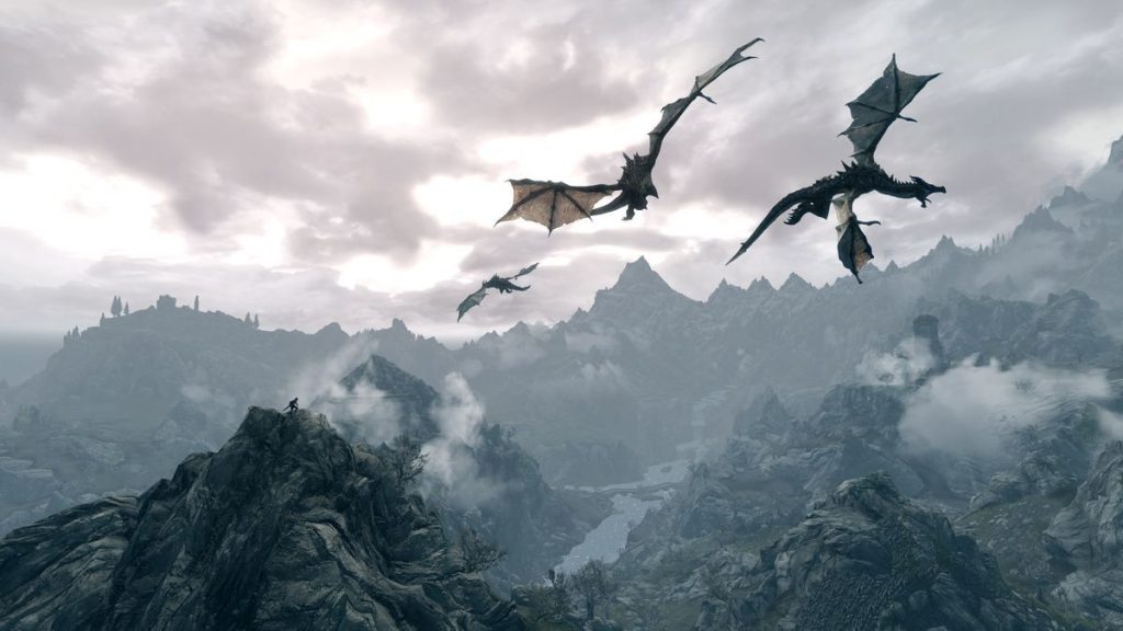 Three dragons soar over a rugged mountain landscape under a cloudy sky. The scene evokes a sense of adventure and fantasy.